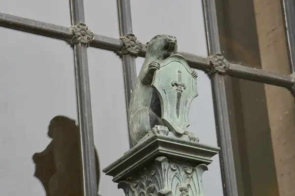 Beaver statue holding shield