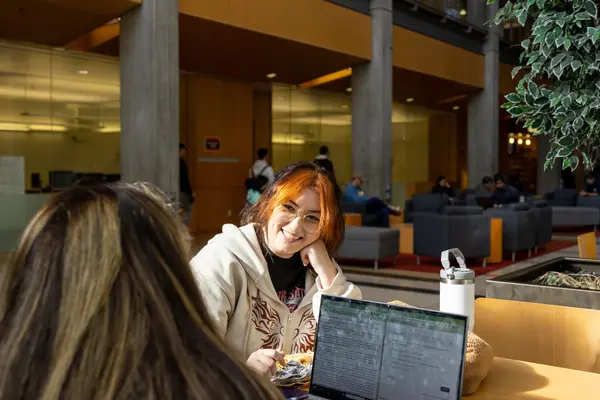 Students working at a table with a laptop